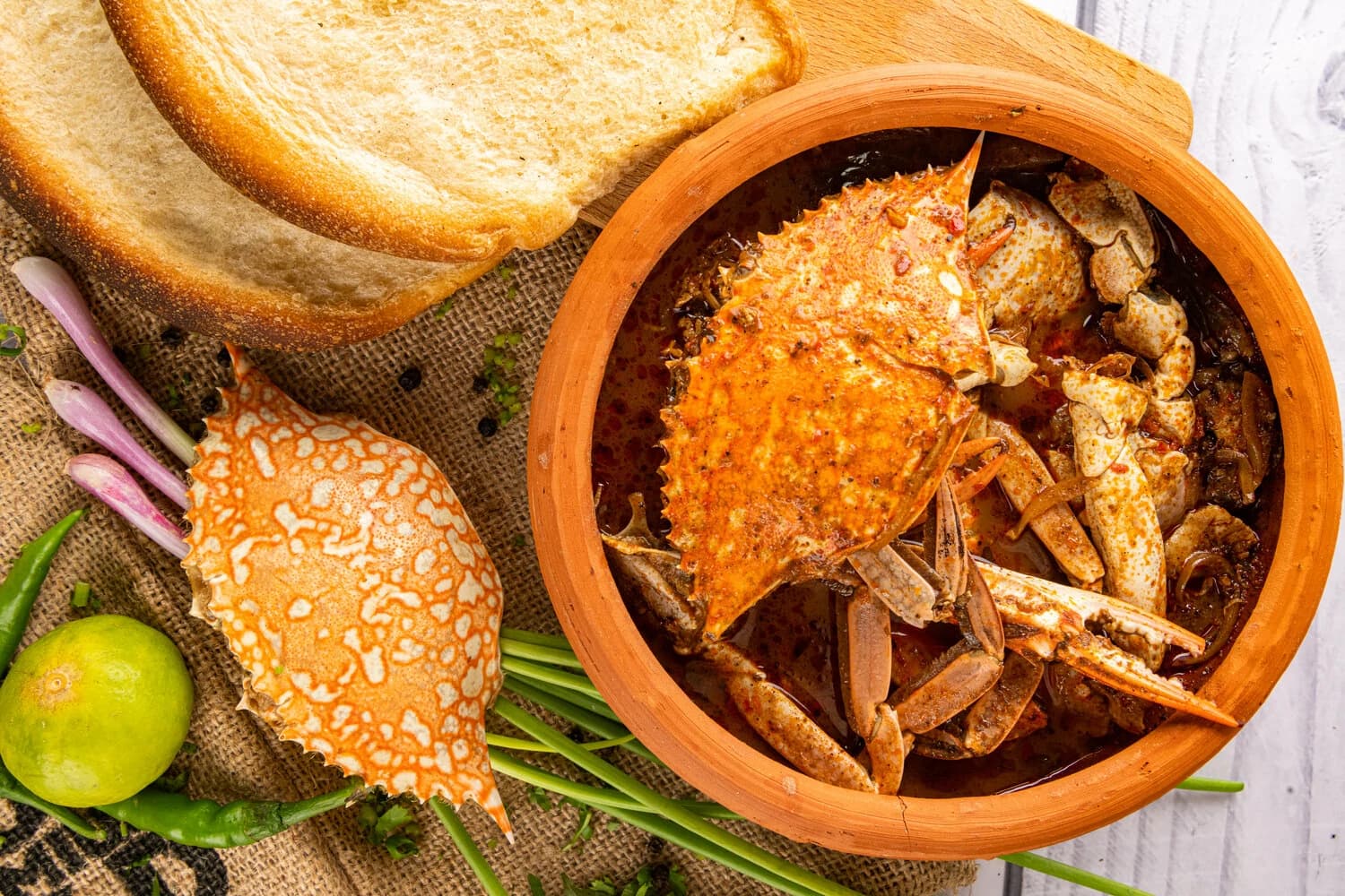 Overhead food photography of a Sri Lankan crab curry spread